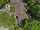 Aerial view of the condo community reveals building rooflines and treetops on a sunny day at 6120 Sunpointe Dr # 102, Raleigh, NC 27606