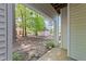 Covered back porch area with views of green trees, wooded area, and the back of other condo buildings at 6120 Sunpointe Dr # 102, Raleigh, NC 27606
