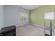 This bedroom has neutral-colored walls and carpet flooring and is illuminated by natural light streaming through the window at 6120 Sunpointe Dr # 102, Raleigh, NC 27606