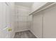 Walk-in closet with metal rack shelving is ready to be organized for storing clothes and other belongings at 6120 Sunpointe Dr # 102, Raleigh, NC 27606