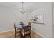 Cozy dining area with a chandelier and wood-style flooring at 6120 Sunpointe Dr # 102, Raleigh, NC 27606