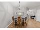 Bright dining area features wood floors, a chandelier, and a pass-through window to the kitchen at 6120 Sunpointe Dr # 102, Raleigh, NC 27606