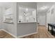 View of foyer with wood floors that opens to the kitchen with white cabinets at 6120 Sunpointe Dr # 102, Raleigh, NC 27606