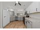 Updated kitchen featuring stainless steel appliances, grey cabinets, and granite countertops at 6120 Sunpointe Dr # 102, Raleigh, NC 27606