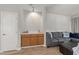 Living room featuring a serving area, a comfortable sofa, and wood-style flooring at 6120 Sunpointe Dr # 102, Raleigh, NC 27606