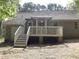 Back exterior of home with a spacious deck and stairs leading to the yard at 640 Sagamore Dr, Louisburg, NC 27549