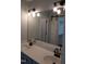 Bathroom featuring a large double vanity, granite countertops, and a sliding barn door in the mirror's reflection at 640 Sagamore Dr, Louisburg, NC 27549