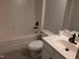 A pristine bathroom features a tub with shower, toilet, and a modern vanity with sink at 640 Sagamore Dr, Louisburg, NC 27549