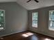 The bright bedroom features a ceiling fan, vinyl flooring, and an abundance of natural light from multiple windows at 640 Sagamore Dr, Louisburg, NC 27549