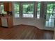 Bright breakfast nook area featuring wood-look flooring and multiple windows with outdoor view at 640 Sagamore Dr, Louisburg, NC 27549
