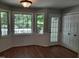 Bright breakfast nook with multiple windows and a door leading to the outdoors at 640 Sagamore Dr, Louisburg, NC 27549
