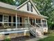 Inviting front porch of single Gathering home featuring fresh white railings and a cozy porch swing at 640 Sagamore Dr, Louisburg, NC 27549