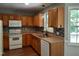 Well-maintained kitchen featuring wooden cabinets, modern appliances, and stylish backsplash at 640 Sagamore Dr, Louisburg, NC 27549