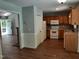 Kitchen with wood cabinets, white appliances, and tile backsplash open to other rooms at 640 Sagamore Dr, Louisburg, NC 27549