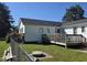 A cozy home featuring a spacious deck perfect for entertaining, set within a lush, green backyard at 66 Epsom Rocky Ford Rd, Henderson, NC 27537