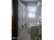 Cozy bathroom featuring a floral shower curtain, a single vanity, and a window for natural light at 66 Epsom Rocky Ford Rd, Henderson, NC 27537