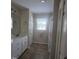 Neutral bathroom featuring a white vanity, tiled floors, and a shower with a colorful curtain at 66 Epsom Rocky Ford Rd, Henderson, NC 27537