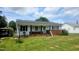 Lovely home with well-maintained lawn, brick accent, and covered parking, offering both curb appeal and convenience at 66 Epsom Rocky Ford Rd, Henderson, NC 27537