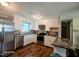 Well-lit kitchen with stainless steel appliances, white cabinetry, and a convenient breakfast bar for casual dining at 66 Epsom Rocky Ford Rd, Henderson, NC 27537