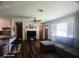 Bright living room with hardwood floors, a large sectional sofa, and an open flow to the kitchen area at 66 Epsom Rocky Ford Rd, Henderson, NC 27537
