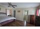 Comfortable main bedroom featuring a ceiling fan, hardwood floors, and private bathroom entrance at 66 Epsom Rocky Ford Rd, Henderson, NC 27537