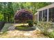 Backyard featuring a Japanese Maple, lush landscaping, and black aluminum fencing at 71 Potted Plant Ct, Clayton, NC 27520
