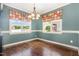 Charming dining area with hardwood floors, neutral paint, and bright windows at 71 Potted Plant Ct, Clayton, NC 27520