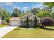 Charming single-story home featuring a manicured lawn and attached two-car garage at 71 Potted Plant Ct, Clayton, NC 27520