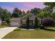 Charming single-story home featuring a manicured lawn and attached two-car garage at 71 Potted Plant Ct, Clayton, NC 27520