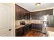 Well-lit kitchen featuring stainless steel appliances and dark wood cabinets at 71 Potted Plant Ct, Clayton, NC 27520