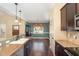 Eat-in kitchen with stainless steel appliances, tile backsplash, and hardwood floors at 71 Potted Plant Ct, Clayton, NC 27520