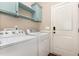 Well-equipped laundry room with washer, dryer, and storage cabinets at 71 Potted Plant Ct, Clayton, NC 27520