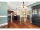 Open-concept living space with hardwood floors connecting the kitchen, dining, and living areas at 71 Potted Plant Ct, Clayton, NC 27520