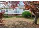 Green backyard featuring a patio and garden, framed by red-leaved trees at 7109 Spanglers Spring Way, Raleigh, NC 27610