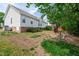 Well-maintained backyard with manicured lawn and white vinyl siding on the house at 7109 Spanglers Spring Way, Raleigh, NC 27610