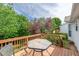 Outdoor deck featuring a table and chairs surrounded by lush greenery at 7109 Spanglers Spring Way, Raleigh, NC 27610