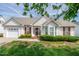 Charming single-story home featuring a well-manicured lawn and attached garage at 7109 Spanglers Spring Way, Raleigh, NC 27610