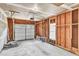 Unfinished garage with automatic door opener, visible framing, and concrete floor at 7109 Spanglers Spring Way, Raleigh, NC 27610