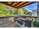 Relaxing outdoor deck with comfortable seating, a wooden pergola, and views of the backyard at 827 Lockesley Ln, Burlington, NC 27217