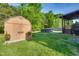 Well-maintained backyard with a storage shed, covered deck, and pool, ideal for outdoor relaxation and entertaining at 827 Lockesley Ln, Burlington, NC 27217