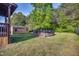 Expansive backyard showcasing a pool and storage shed surrounded by well-maintained grass, offering ample space at 827 Lockesley Ln, Burlington, NC 27217