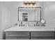 Bathroom featuring double sinks, modern lighting, and contemporary decor at 827 Lockesley Ln, Burlington, NC 27217