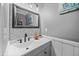 Stylish bathroom featuring a modern sink, decorative mirror, and tiled backsplash at 827 Lockesley Ln, Burlington, NC 27217