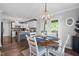 Cozy dining area adjacent to kitchen with wooden table, chairs, and a rustic chandelier fixture at 827 Lockesley Ln, Burlington, NC 27217