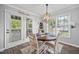 Inviting dining area features a round wood table, four chairs, and French doors to the backyard patio at 827 Lockesley Ln, Burlington, NC 27217