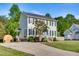Two-story home with gray siding, black shutters, concrete drive, and well-kept lawn at 827 Lockesley Ln, Burlington, NC 27217
