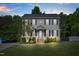 Charming two-story home with gray siding, black shutters, and manicured front yard at 827 Lockesley Ln, Burlington, NC 27217