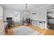 Spacious home office with hardwood floors, a modern chandelier, and large window offering natural light at 827 Lockesley Ln, Burlington, NC 27217