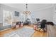 Bright home office with hardwood floors, natural light, and ample space for multiple workstations at 827 Lockesley Ln, Burlington, NC 27217