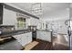 Well-lit kitchen with white cabinets, stone backsplash, stainless appliances, and an open view to the dining area at 827 Lockesley Ln, Burlington, NC 27217